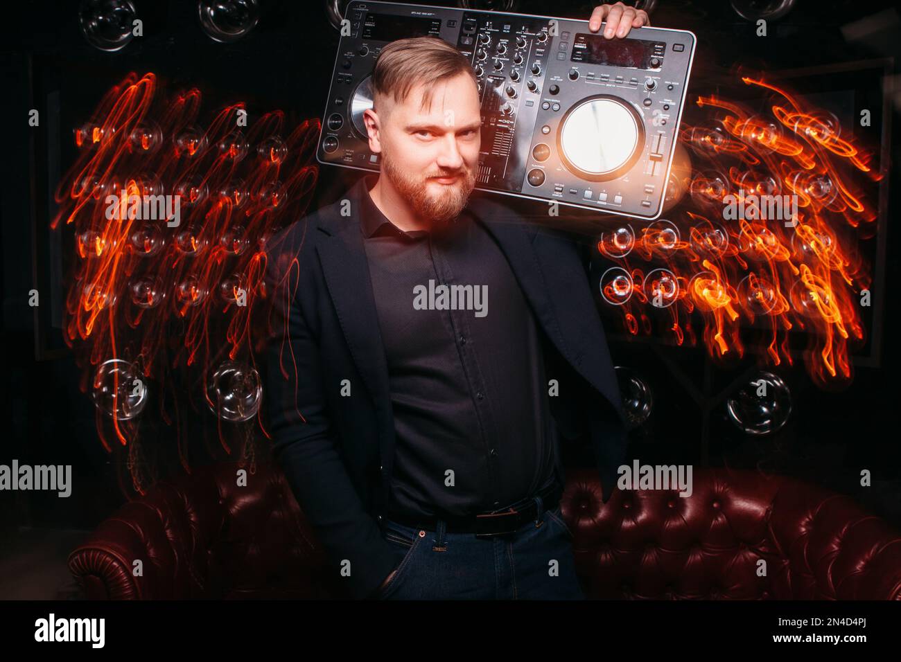 Disc Jackey Young professional disk jockey holding DJ console Stock Photo - Alamy