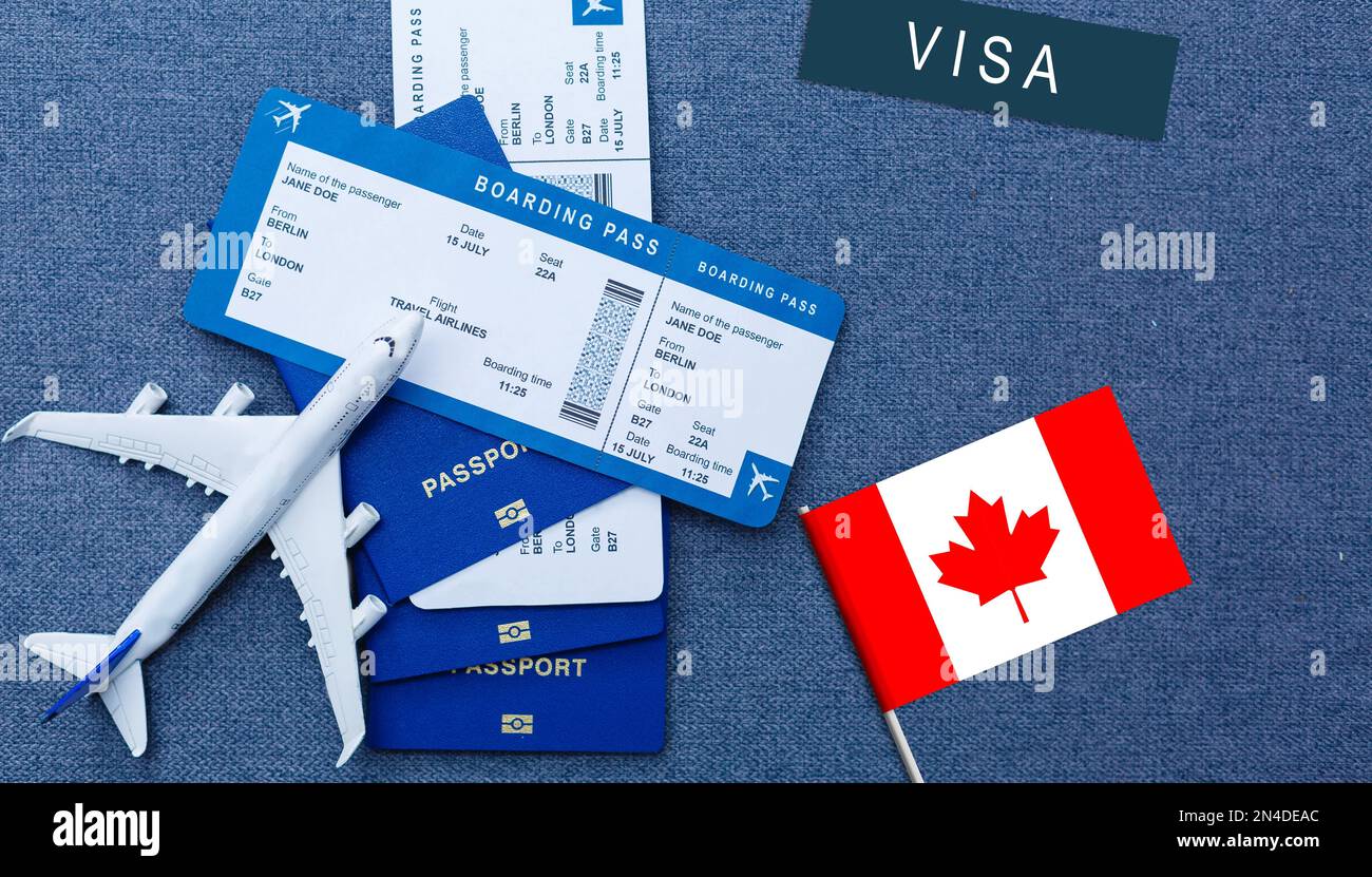 Flag of Canada with passport and toy airplane. Flight travel concep Stock Photo