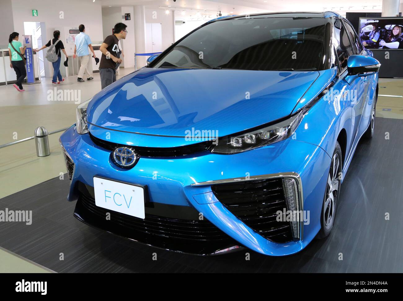 In this June 26, 2014 photo, a visitor looks at Toyota Motor's new fuel