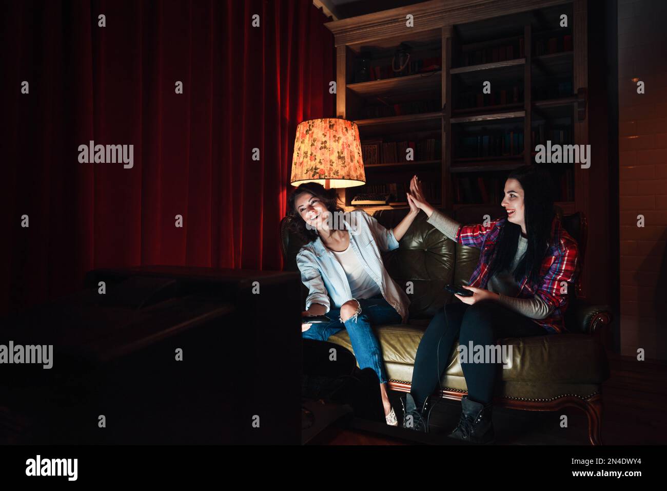 Successful video game play. Two happy young girls Stock Photo - Alamy