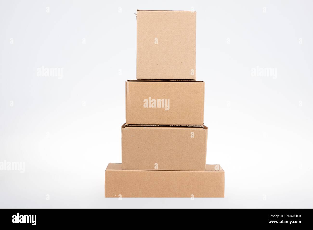 stack of pyramid four cardboard boxes of different sizes on white ...