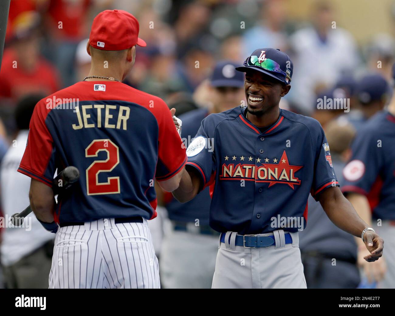 American League's Derek Jeter (L) talks with teammate Miguel