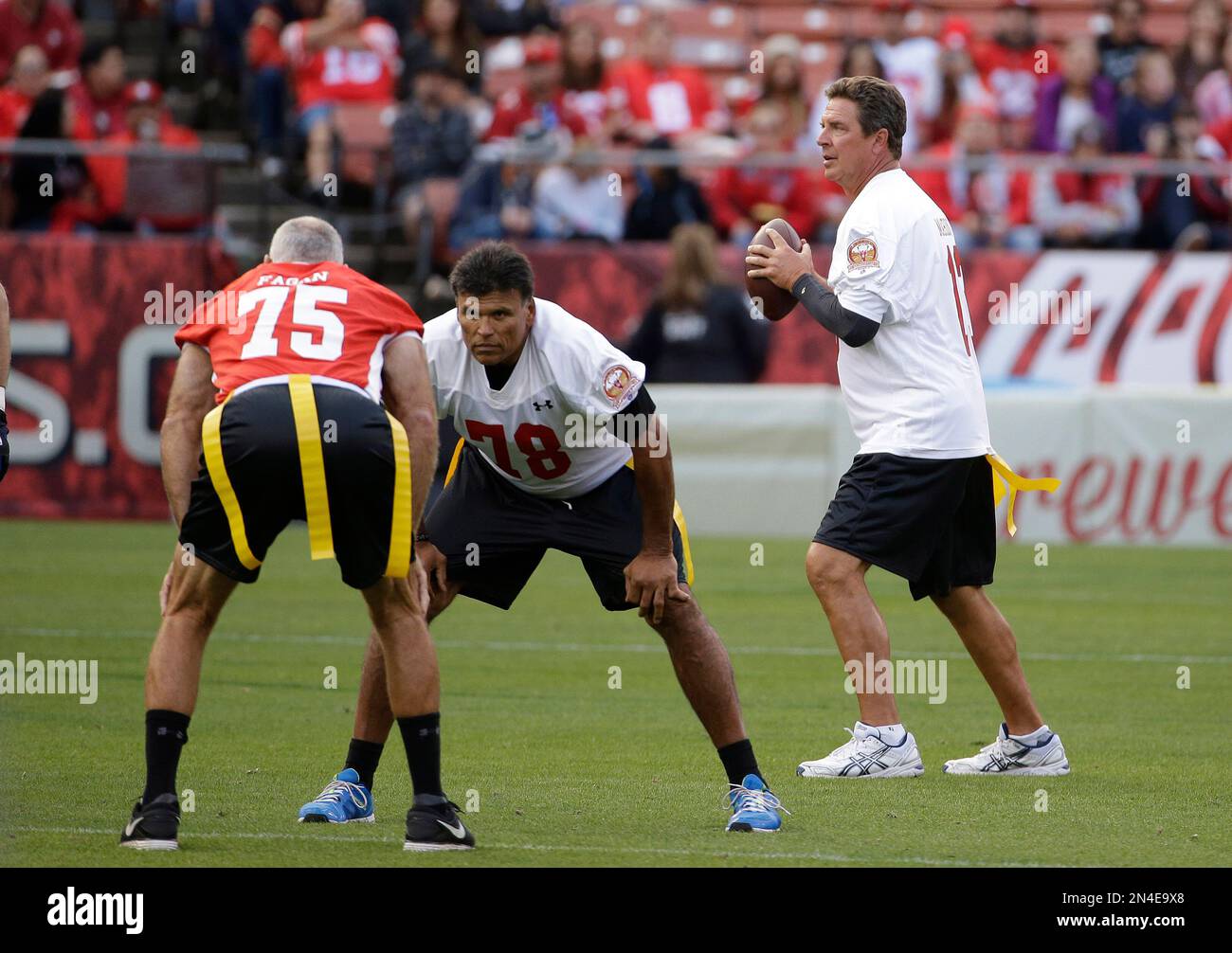Miami Dolphins Hall of Famer Dan Marino, right, drops back to throw ...