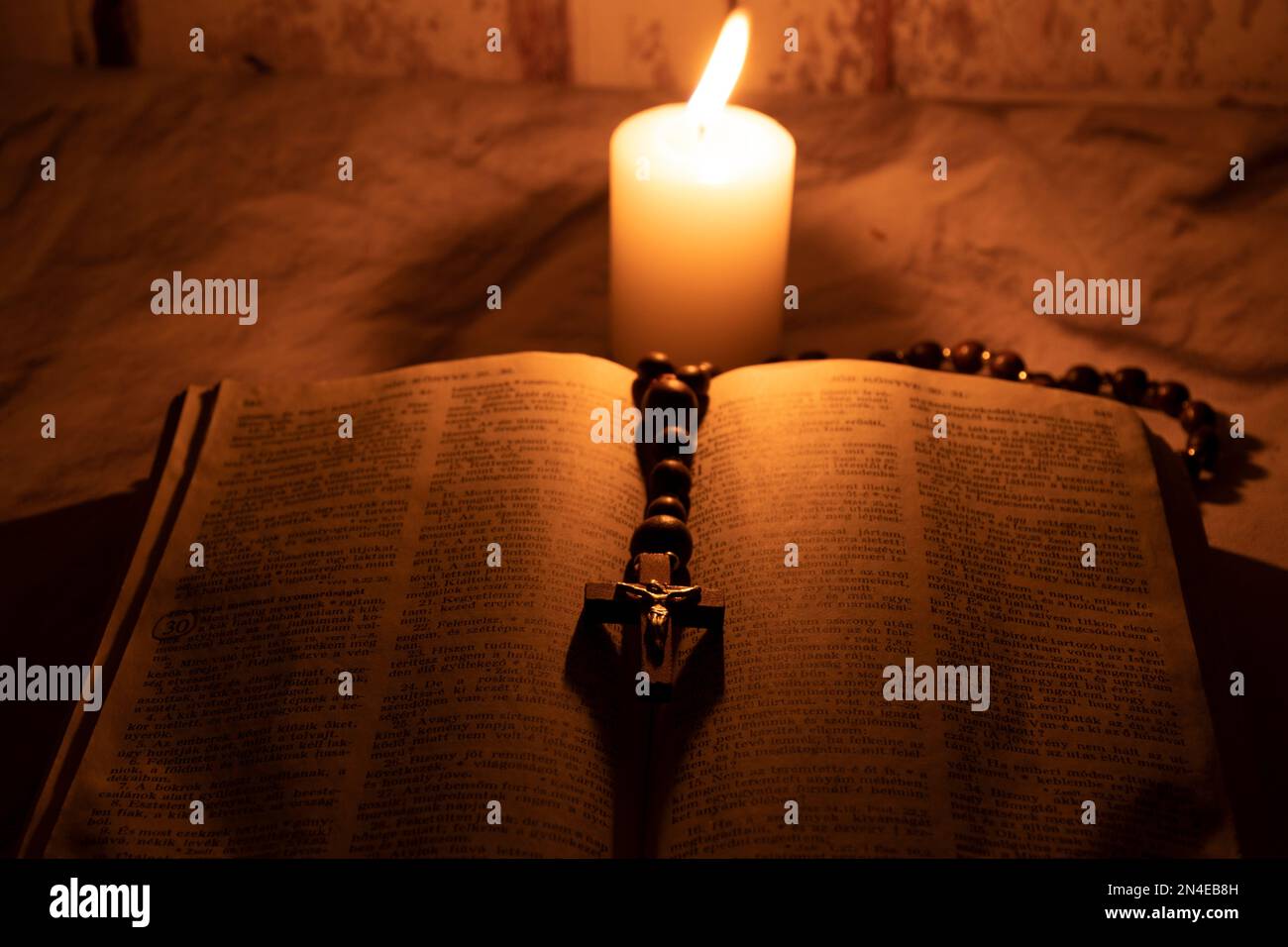 Holy bible, rosary, and candle Stock Photo Alamy