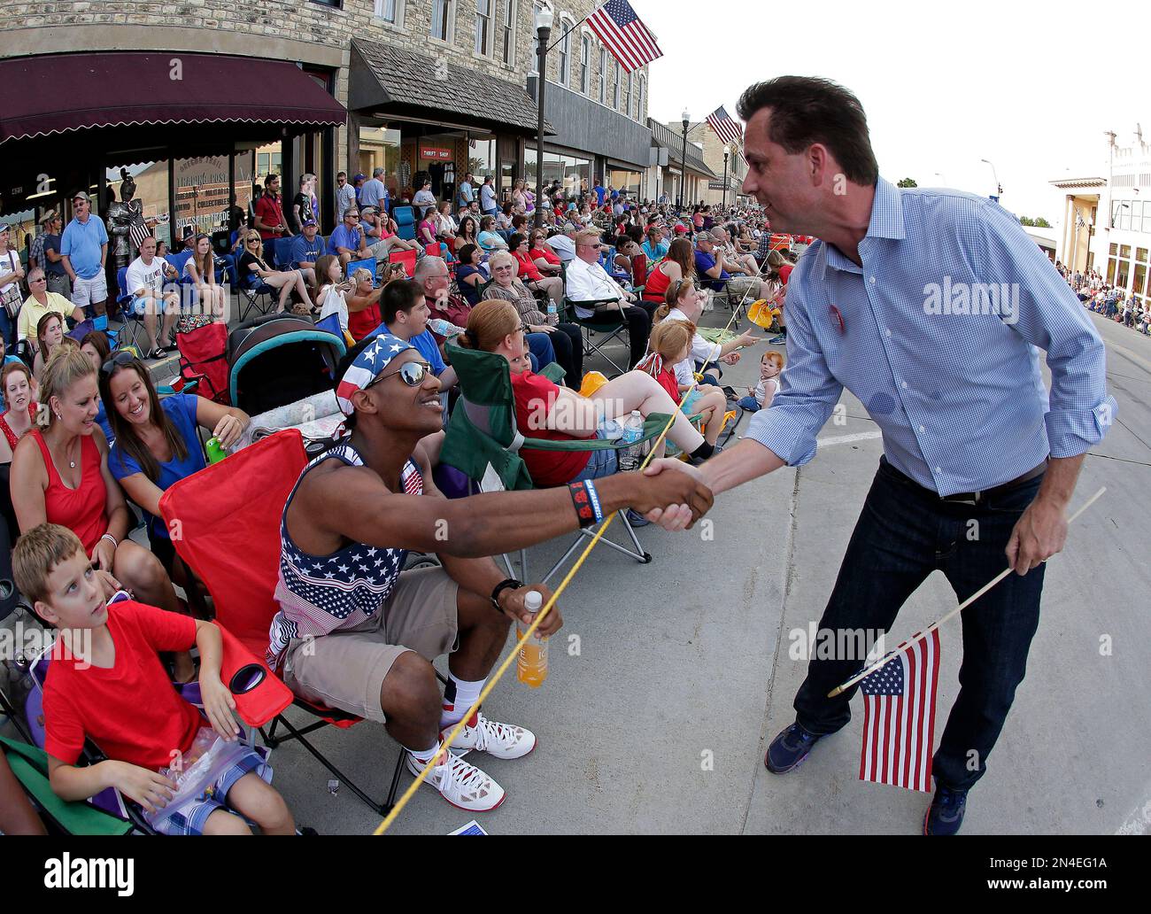 In this photo taken July 4, 2014, Milton Wolf, works the crowd at a