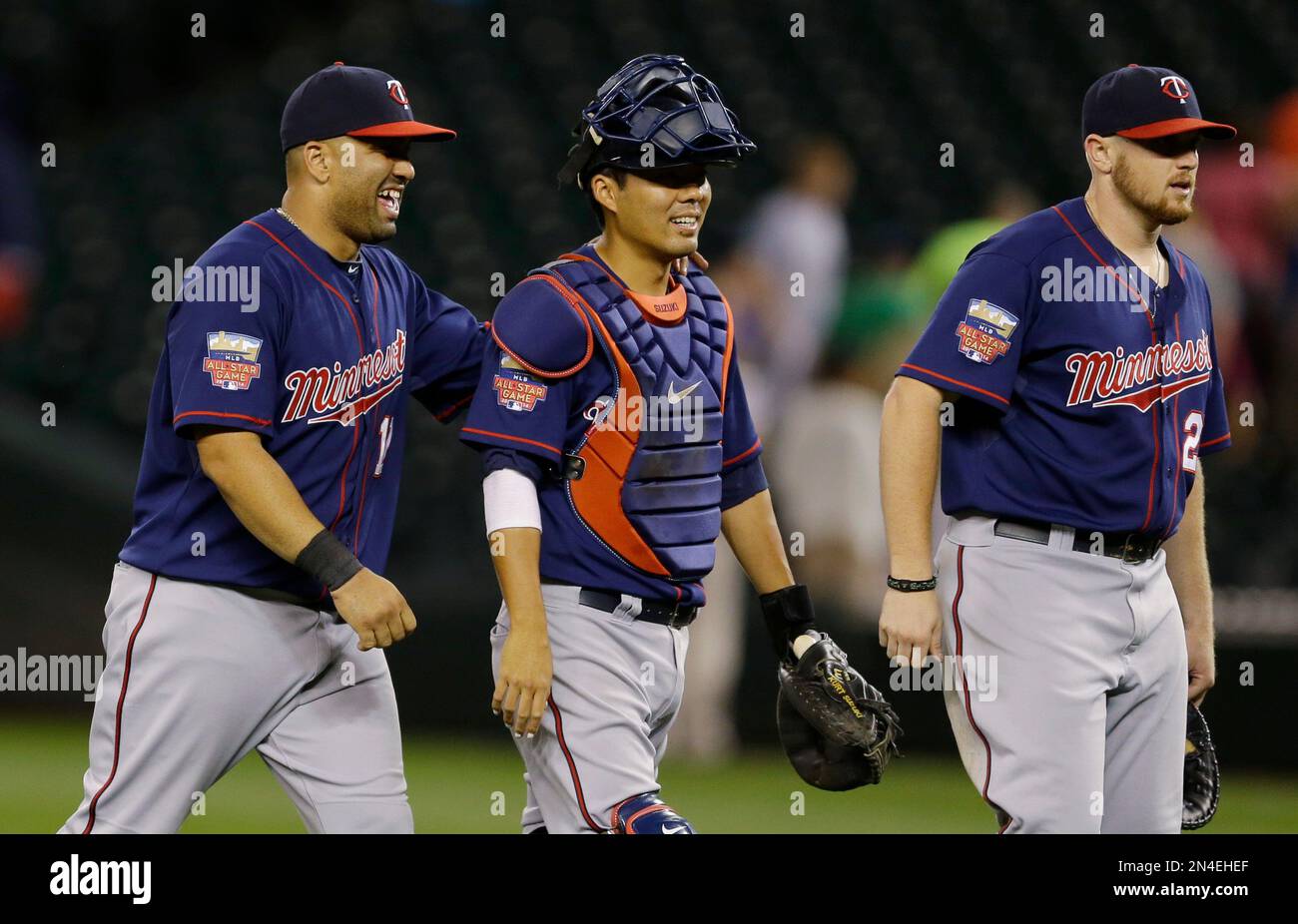 Minnesota Twins' Kendrys Morales, left, catcher Kurt Suzuki, and first  baseman Chris Parmelee, right, walk to greet teammates after they defeated  the Seattle Mariners 4-2 in a baseball game on Thursday, July