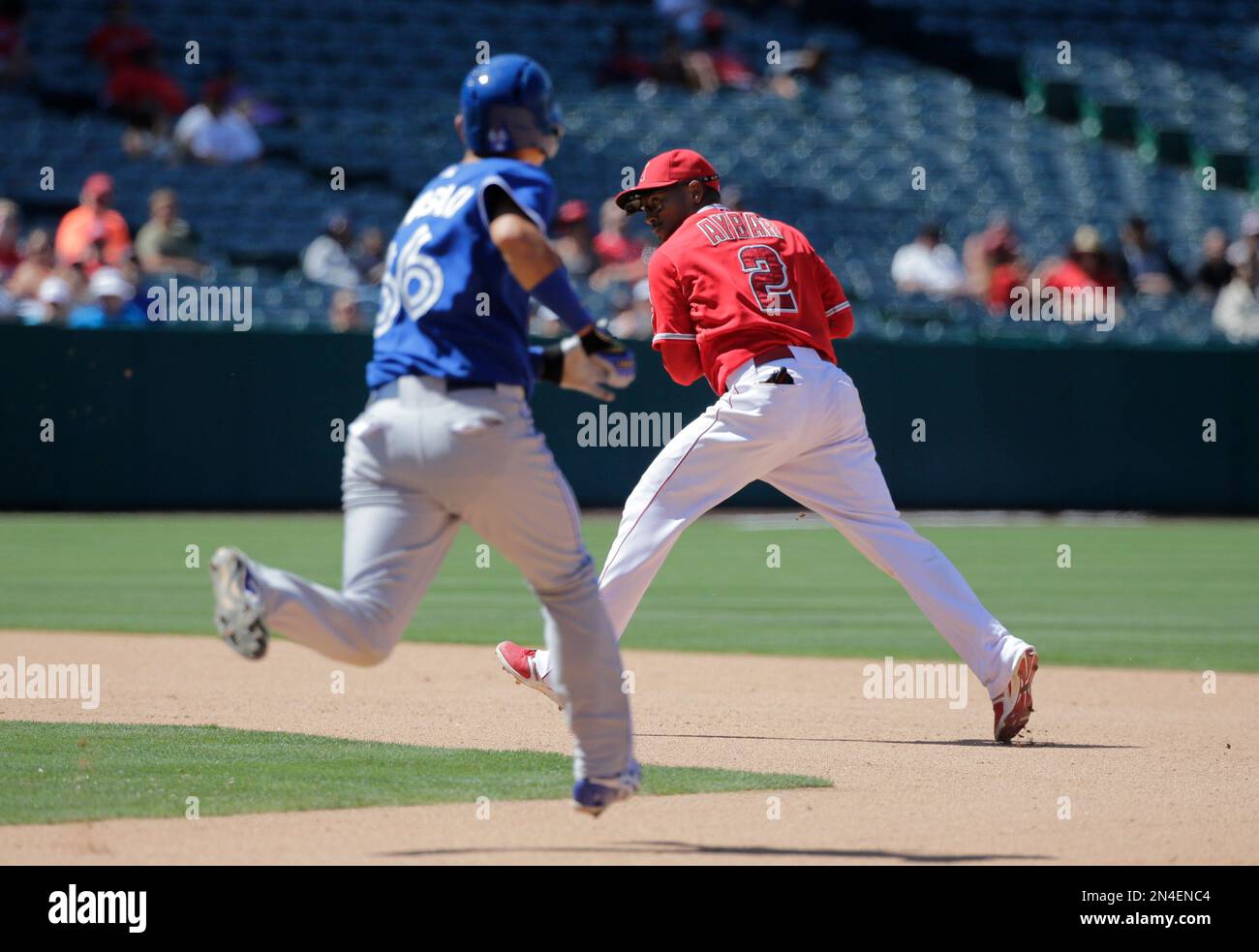 Los Angeles Angels' Erick Aybar, right, looks to throw to first base as ...