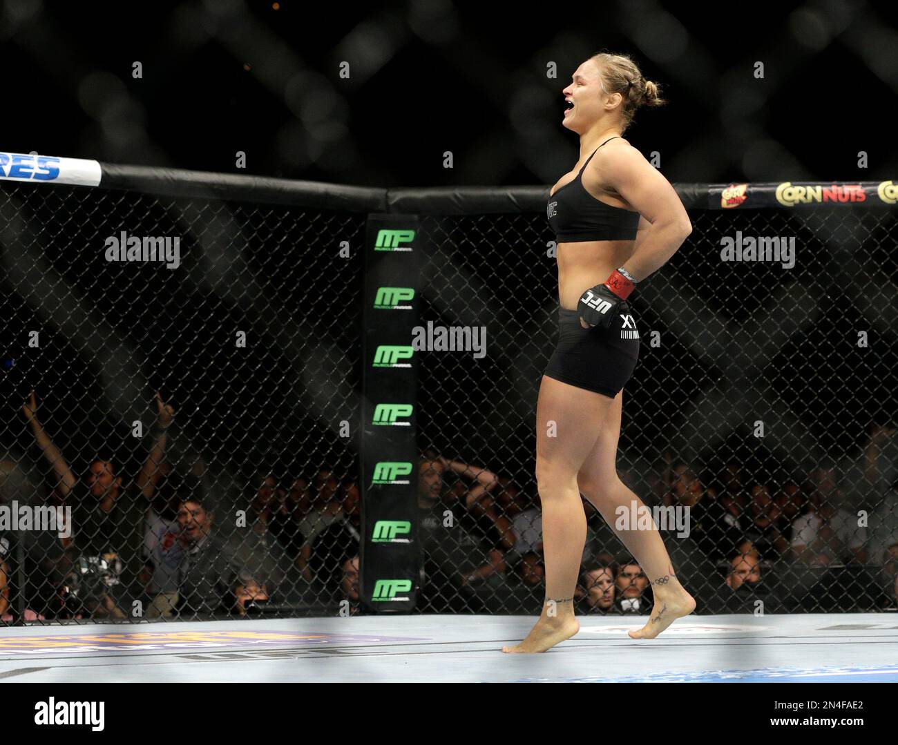 Ronda Rousey celebrates after defeating Alexis Davis in their women's