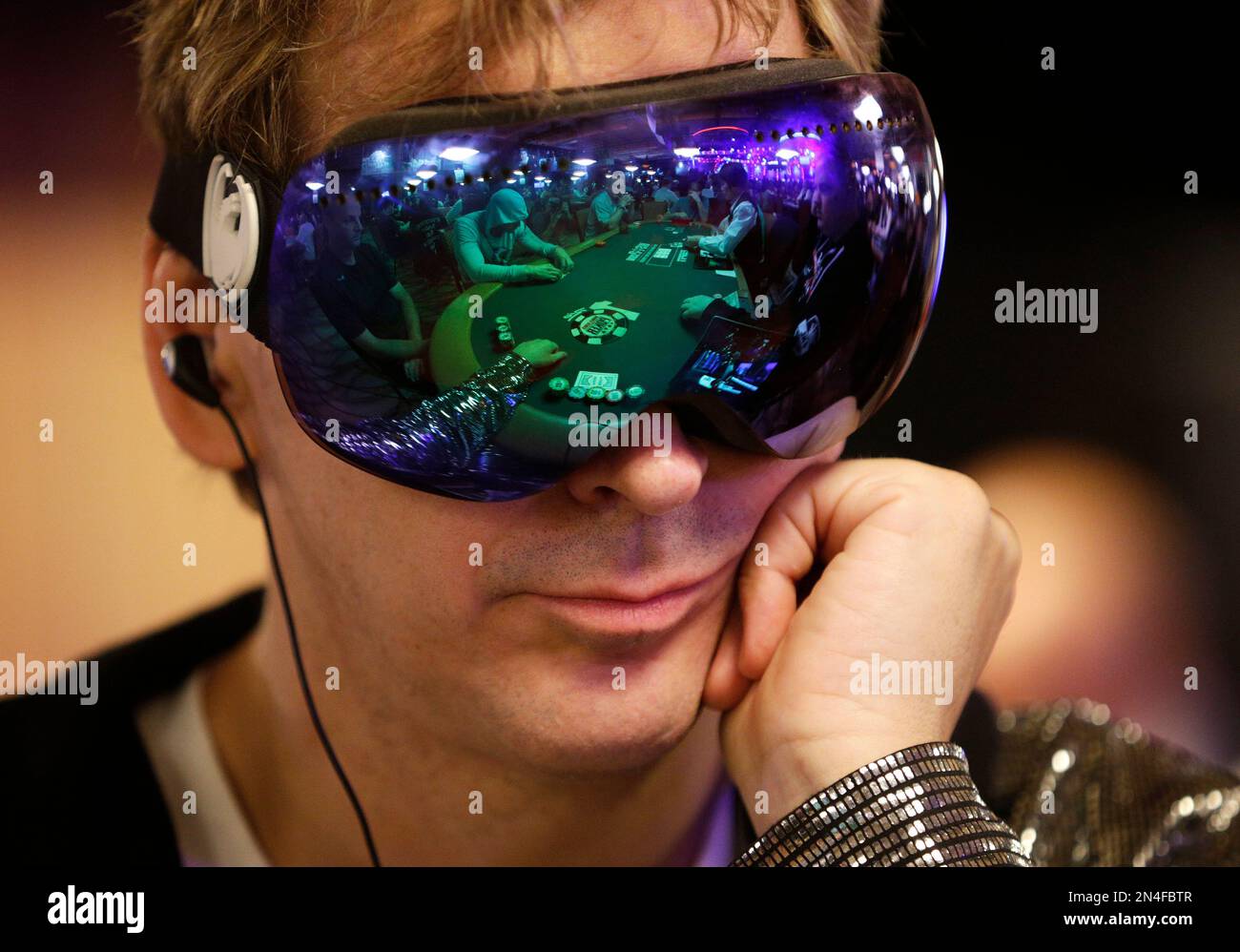 Phil Laak wears goggles while he plays on the first day of the World Series of Poker main event Saturday, July 5, 2014, in Las Vegas. Players will be vying for the $10 million first-place payout at the poker tournament. (AP Photo/John Locher) Stock Photo