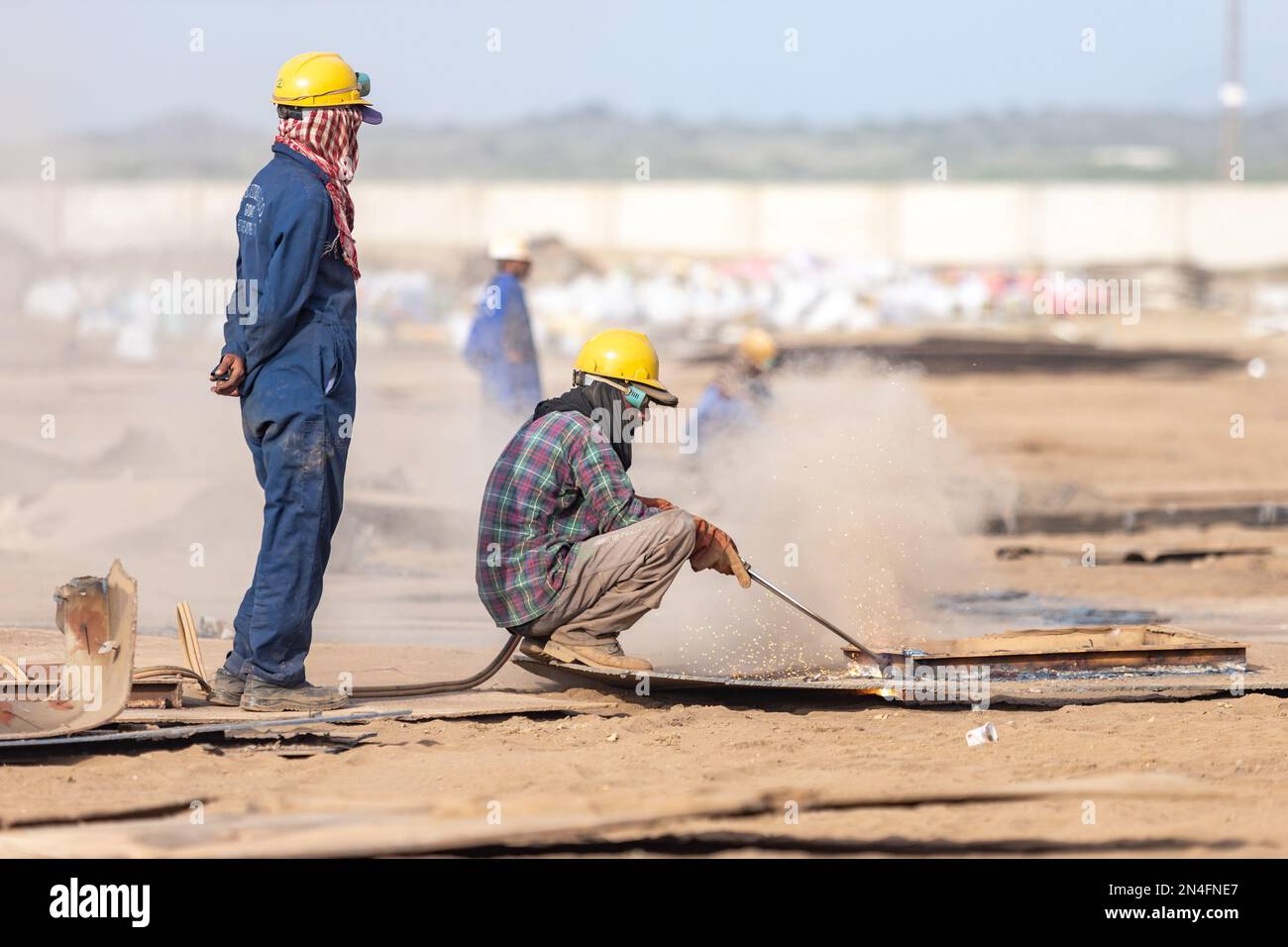 Gadani Pakistan August 2021, a worker wearing safety helmet cutting