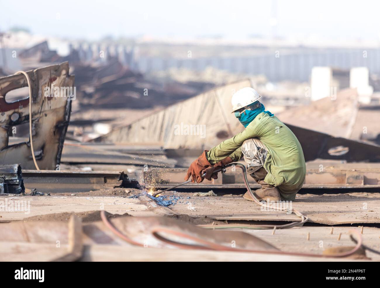 Gadani Pakistan August 2021, a worker wearing safety helmet cutting