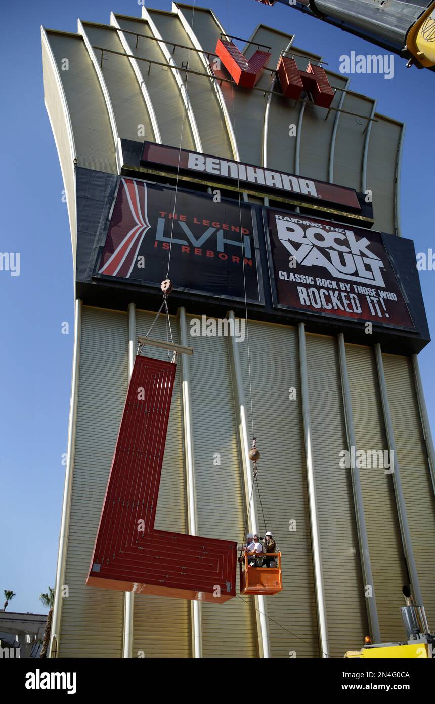 Construction workers lower part of the LVH sign Tuesday, July 1, 2014 in  Las Vegas. Westgate Resorts, a timeshare company, is the new owner of the  hotel and casino. (AP Photo/John Locher