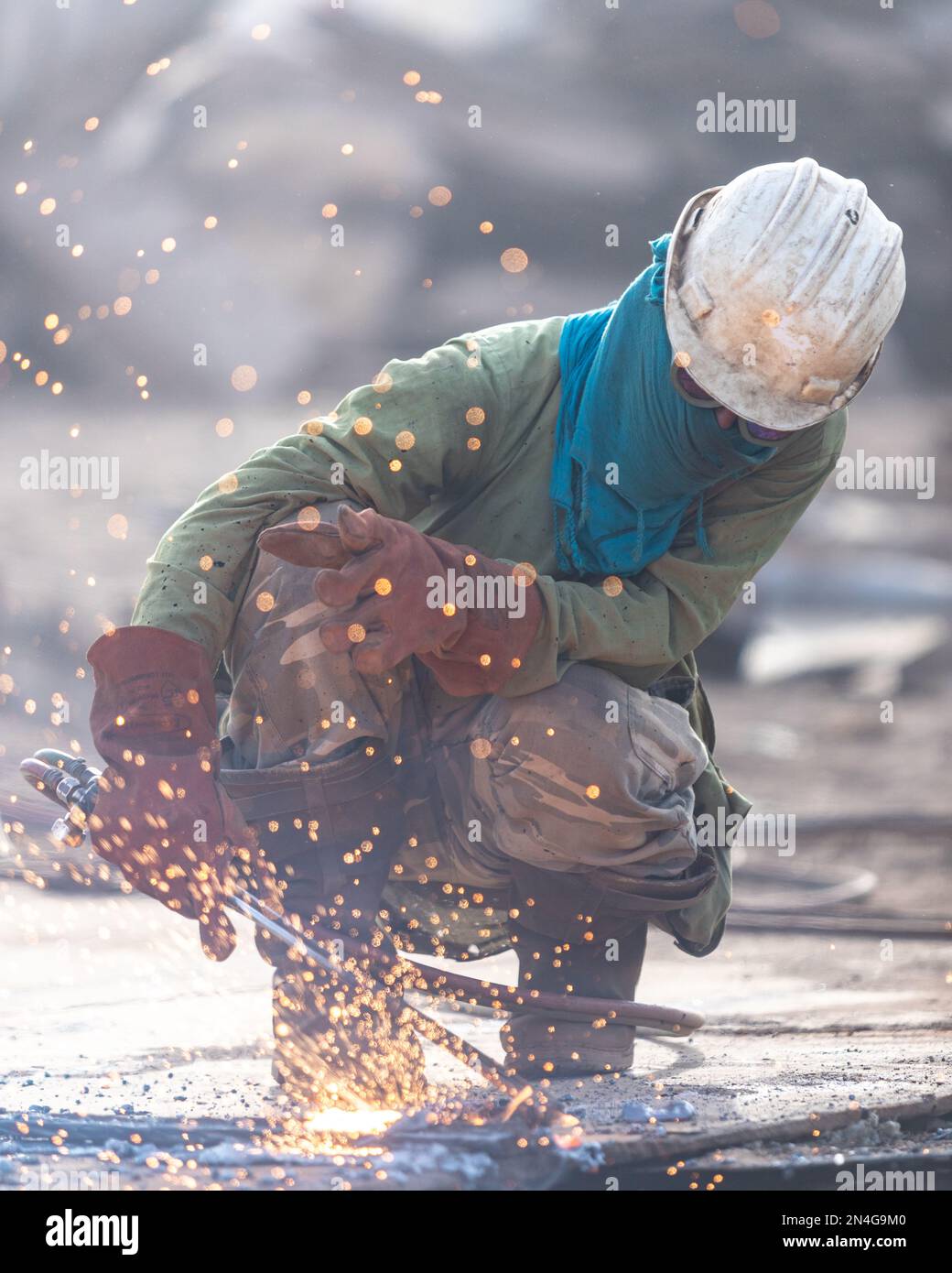 Gadani Pakistan August 2021, a worker wearing safety helmet cutting
