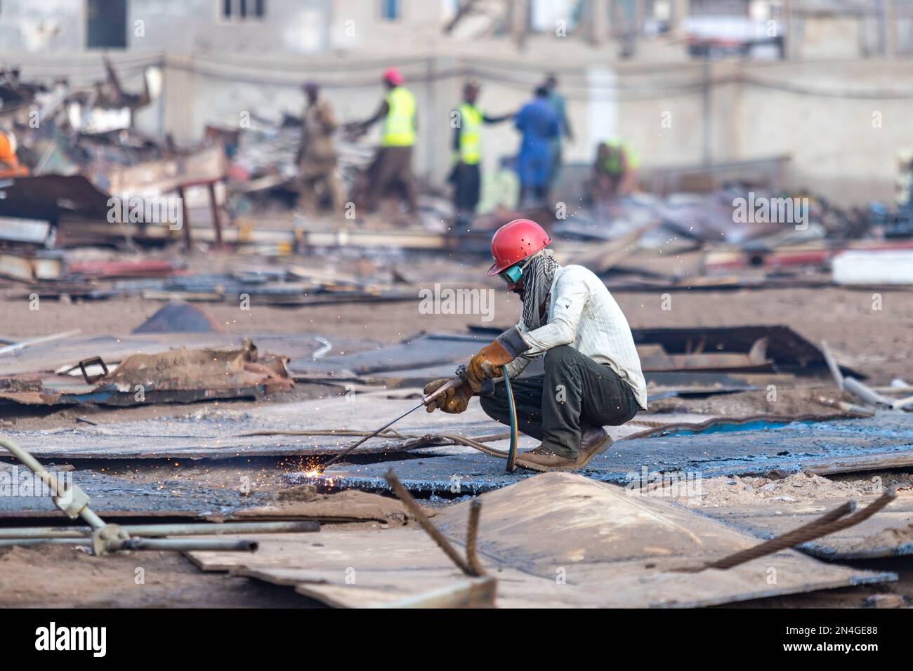 Gadani Pakistan August 2021, a worker wearing safety helmet cutting
