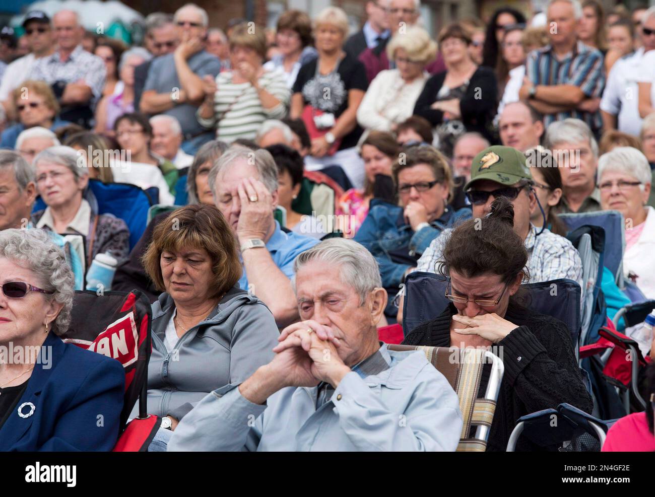 Mourners Watch A Memorial Service On A Giant Screen Outside During A mourners-watch-a-memorial-service-on-a-giant-screen-outside-during-a