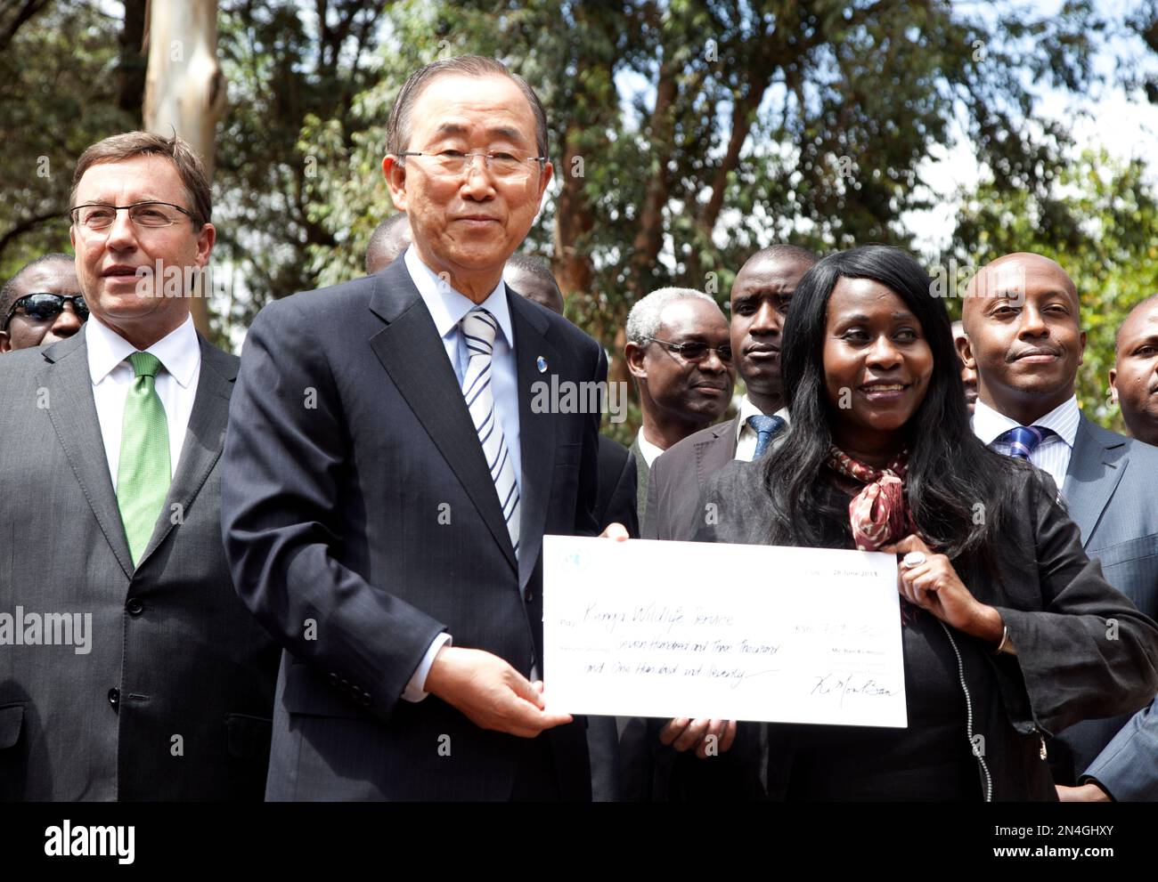 United Nations Secretary General Ban Ki-moon , second left, presents a ...
