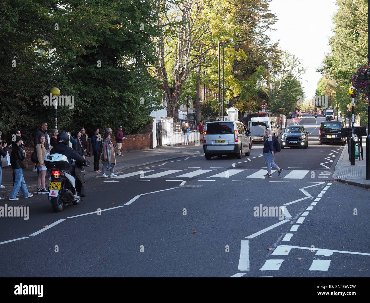 LONDON, UK CIRCA OCTOBER 2022 People crossing Abbey Road zebra