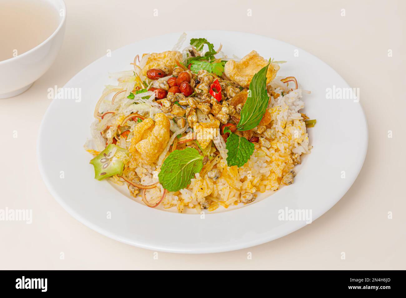 Com hen Hoi An, Vietnamese rice dish with baby basket clams rice, Vietnamese food isolated on white background; close-up Stock Photo