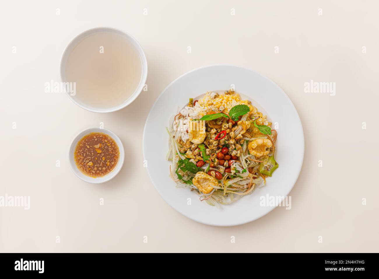 Com hen Hoi An, Vietnamese rice dish with baby basket clams rice, Vietnamese food isolated on white background; top view Stock Photo