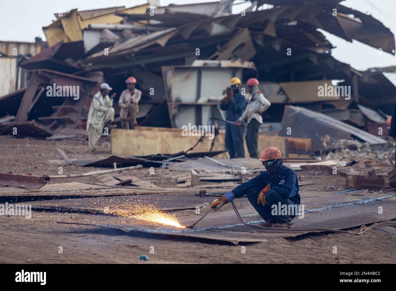 Gadani Pakistan August 2021, a worker wearing safety helmet cutting
