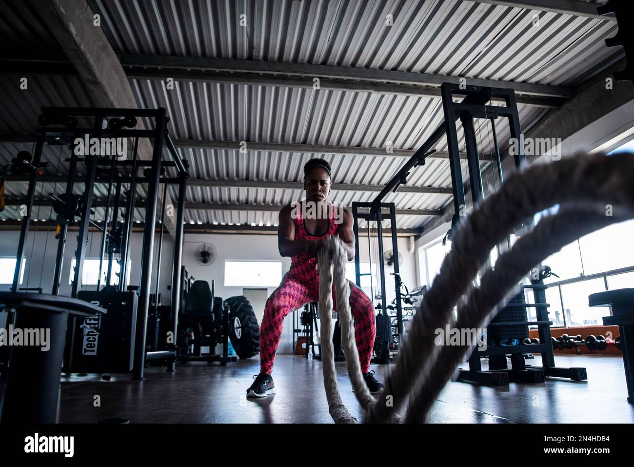 Woman doing training with naval rope. Abdominal strengthening and ...