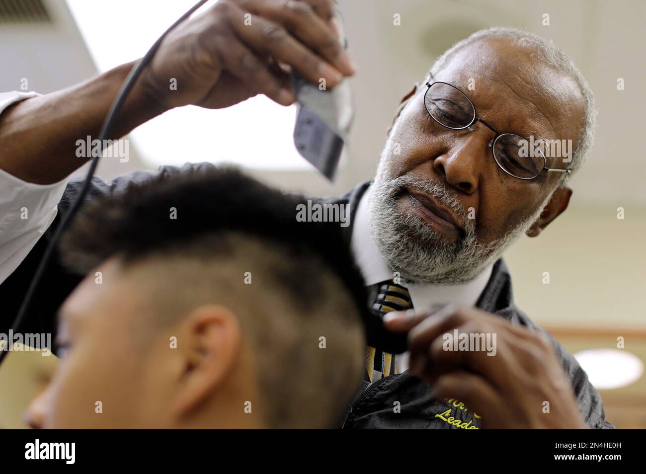 In this June 23, 2014 picture, barber Ernest "Smitty" Smith gives
