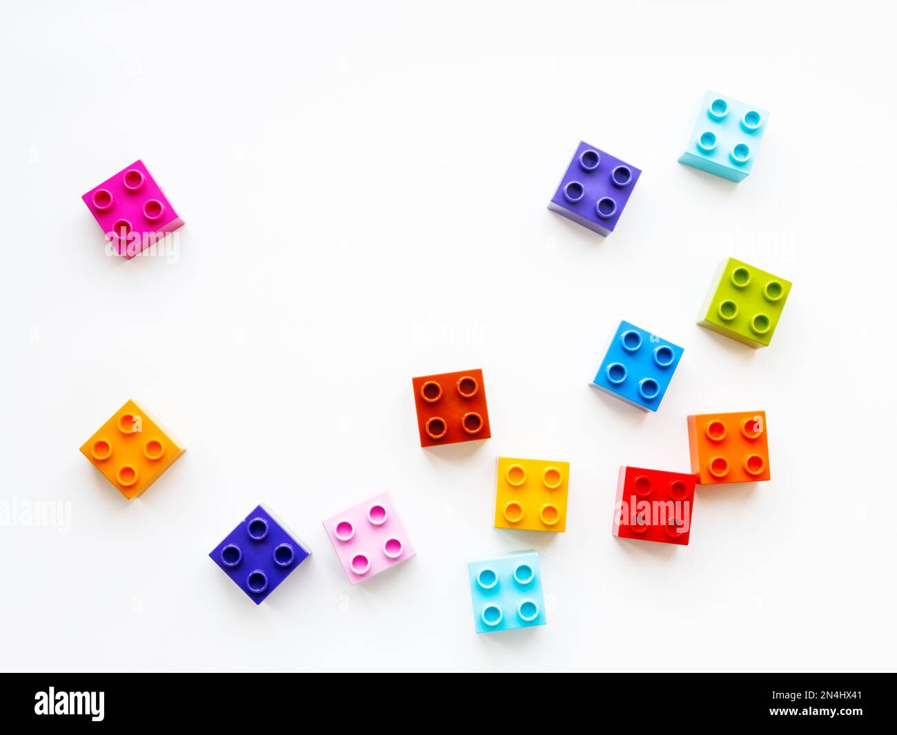 Colorful constructor blocks. Toy bricks lyingwithout order. Place for text among multicolored toy details. Stock Photo