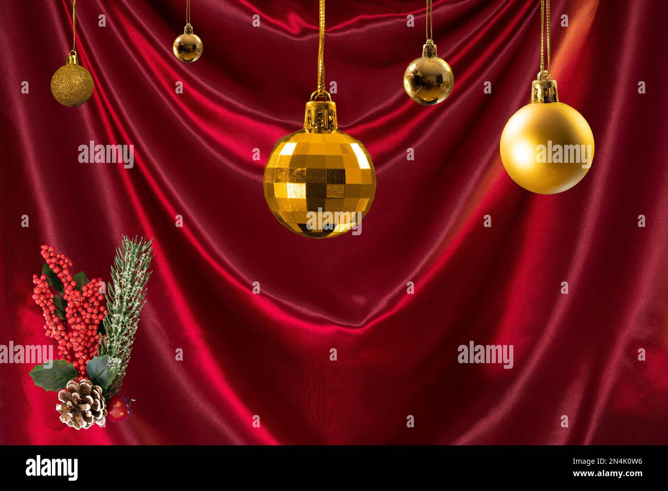 A red background with golden Christmas baubles Stock Photo