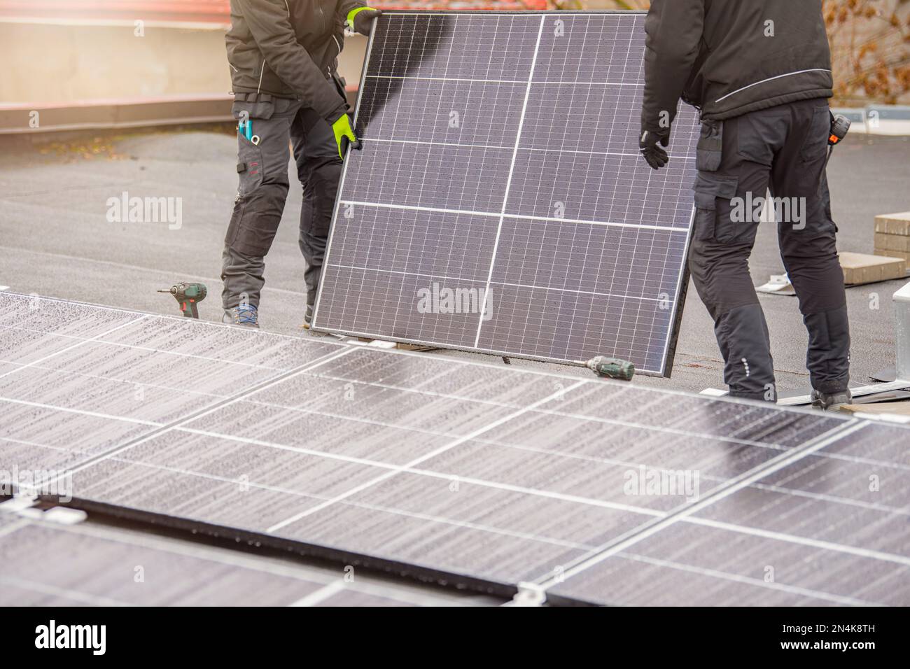 The process of installing solar panels. Solar panel installers work on