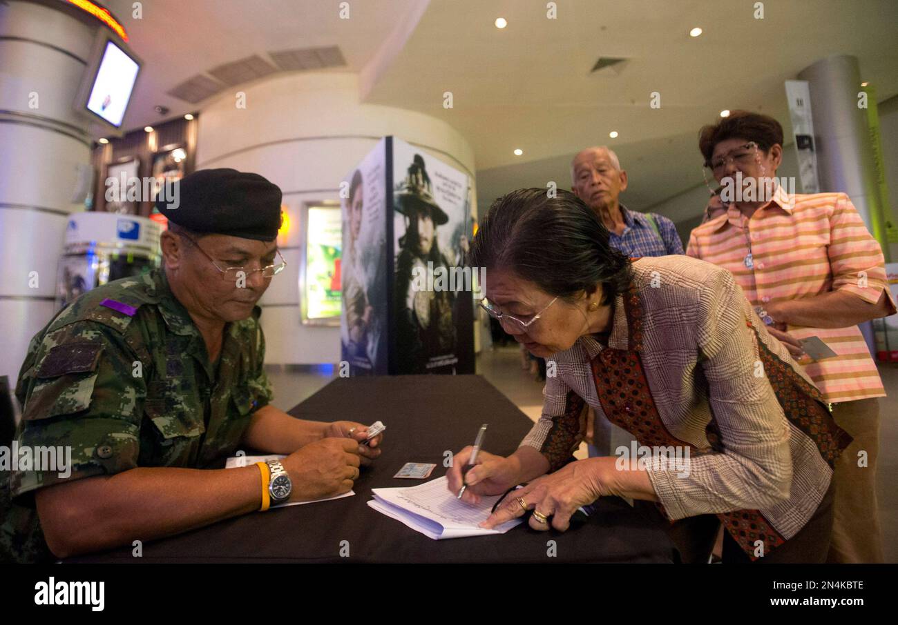 A woman receives a free ticket for the film 'The Legend of King Naresuan 5'  from a Thai soldier at a shopping mall during an event as part of the  military junta's