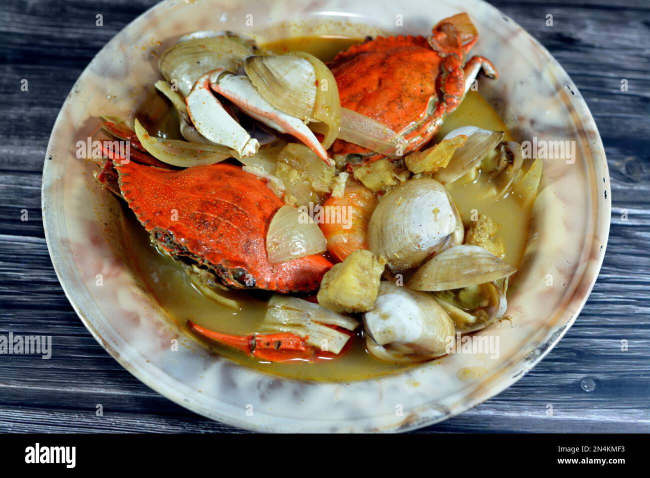 Hot soup meal of various fresh seafood marine crabs, shrimps, clams