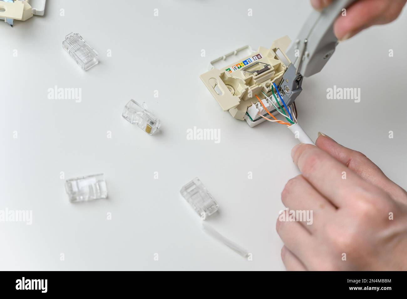 installing a wall ethernet socket. Connecting wires to an socket Stock