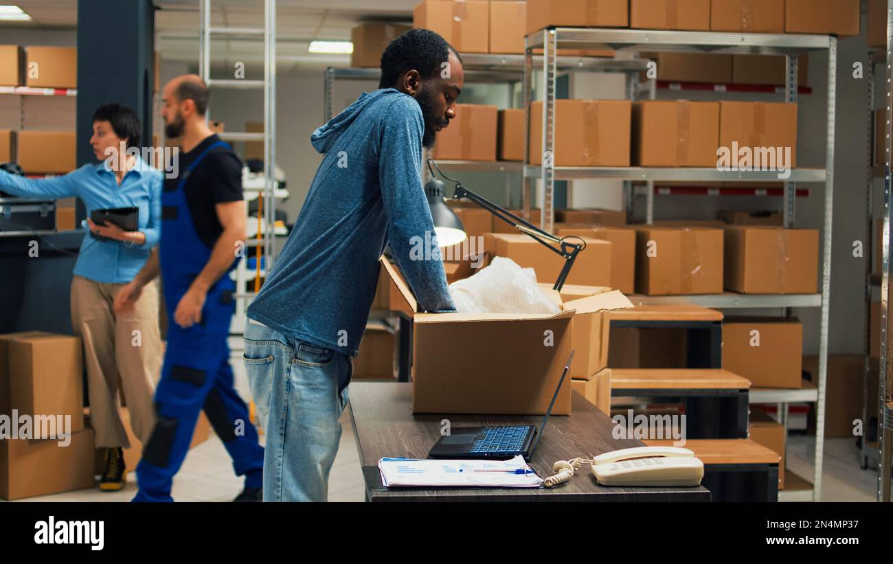 African american owner taking products from storage racks to prepare ...
