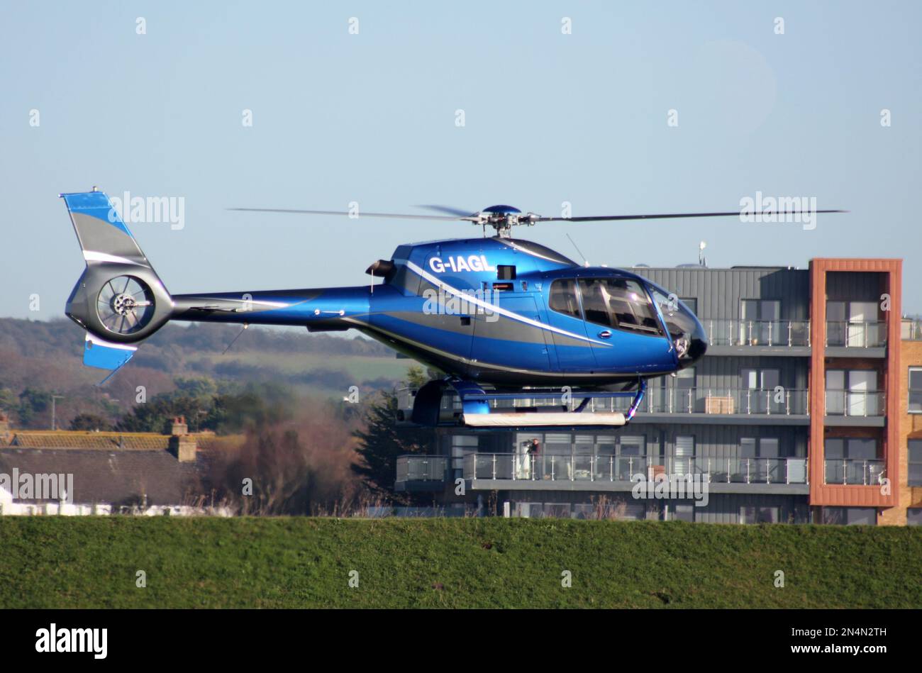 A Eurocopter EC 120 Colibri helicopter arriving at Brighton City Airport Stock Photo
