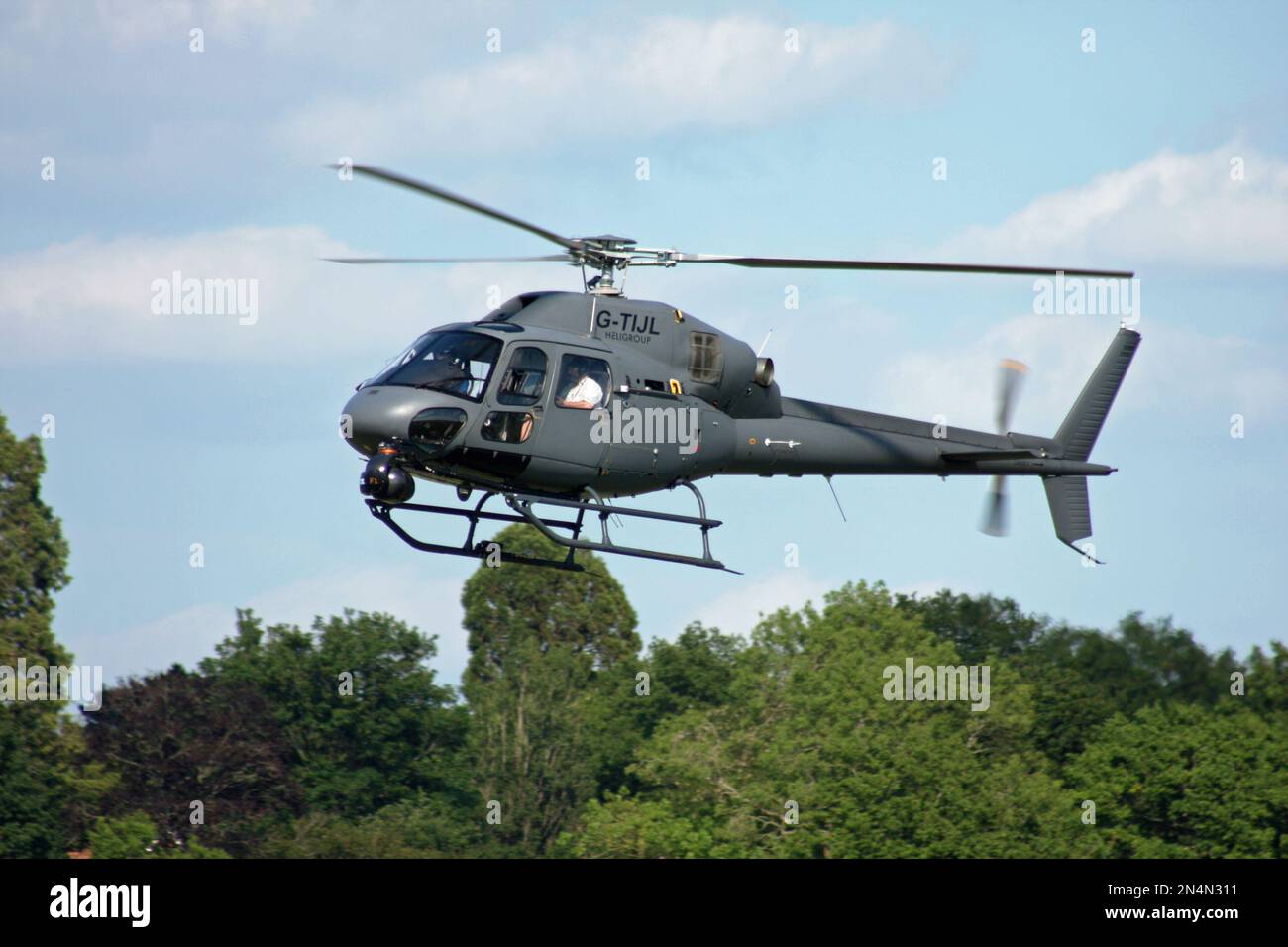 A Eurocopter AS 355NP Ecureuil 2 of Heligroup landing at Redhill Aerodrome Surrey Stock Photo