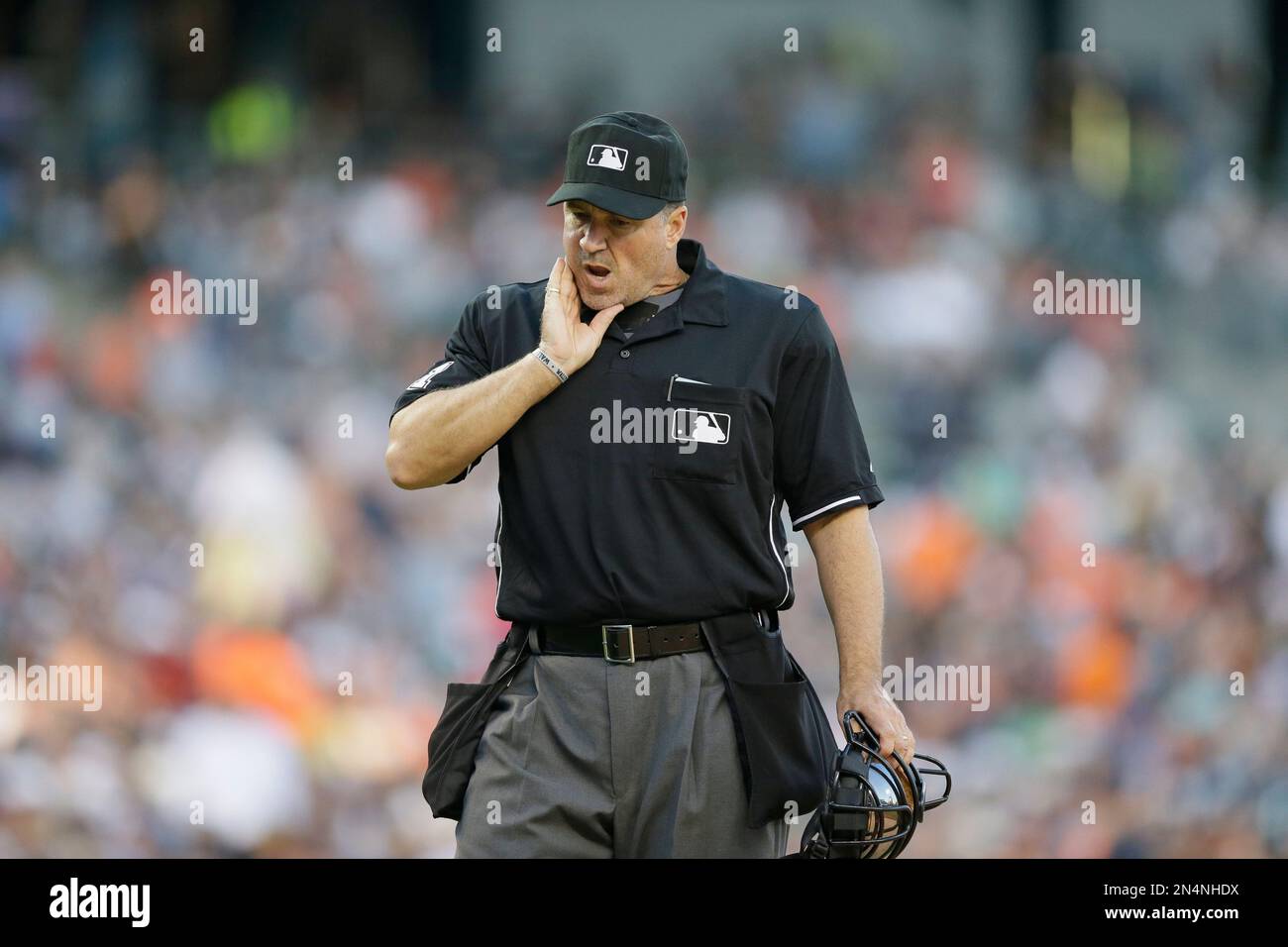 Homeplate umpire Tony Randazzo checks his jaw in the sixth inning after
