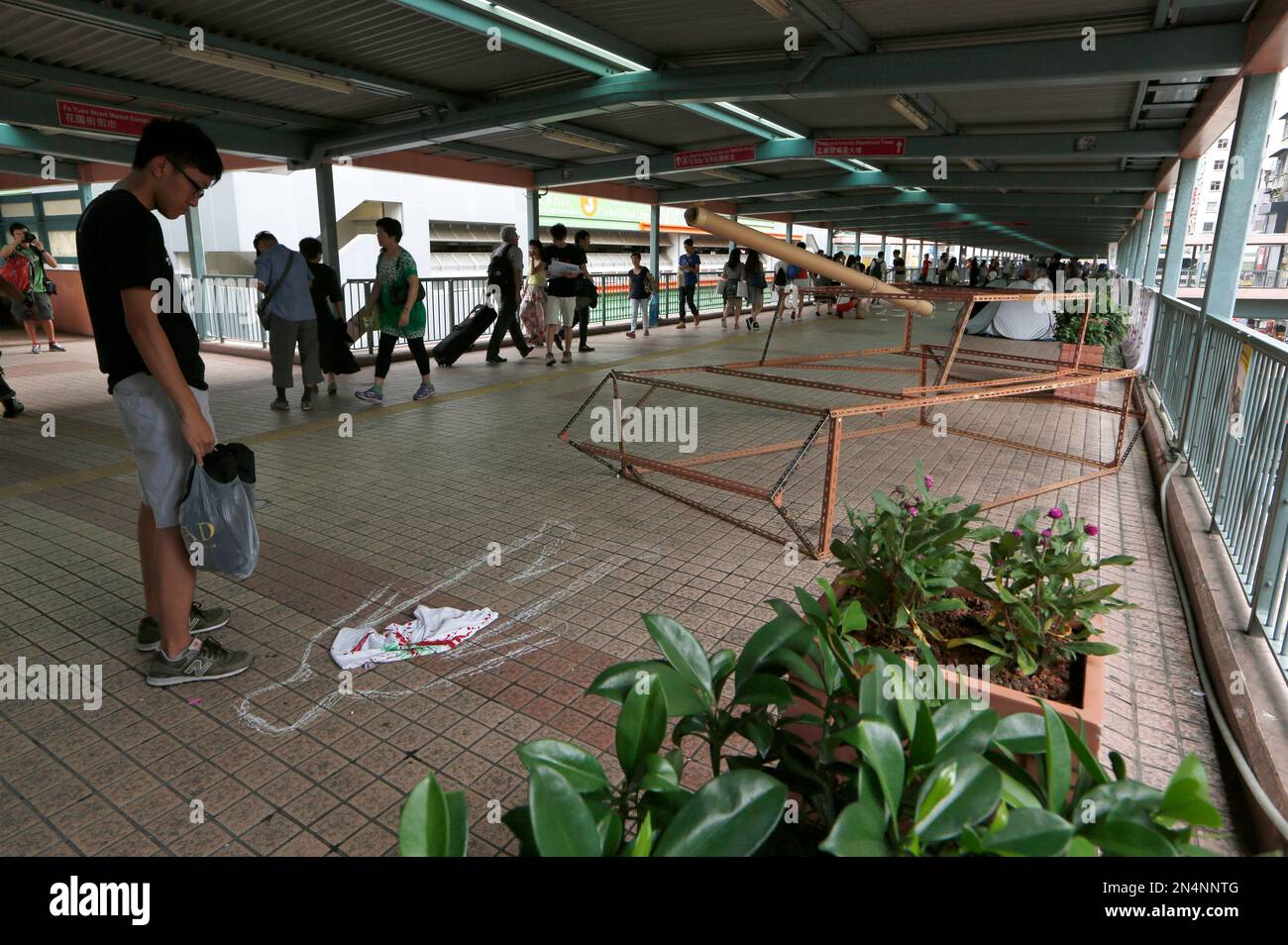 A university student stands in front of a mock tank to symbolize the