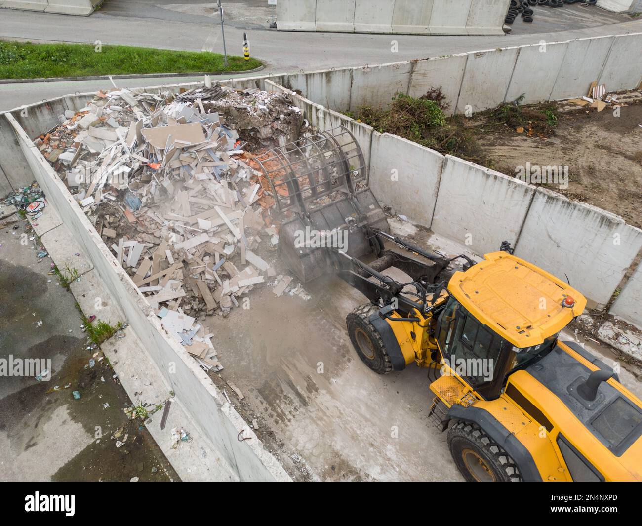 Handling construction waste on the landfill site, skid steer loader