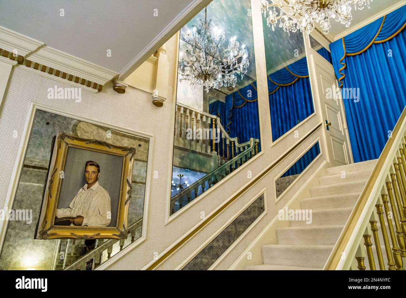 The main staircase with oil portrait of Elvis in Graceland, the home of Elvis Presley in Memphis, Tennessee. Stock Photo