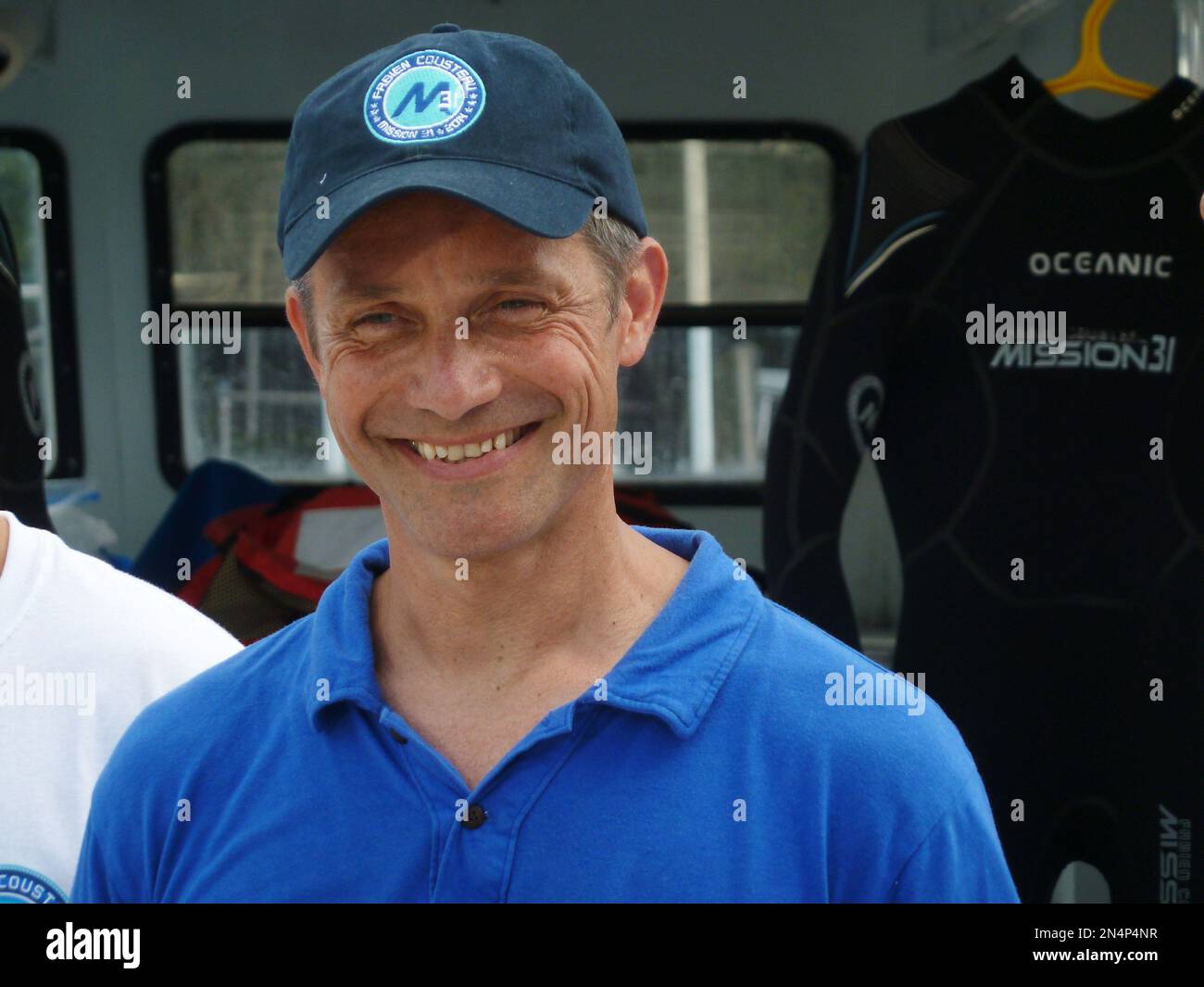 Fabien Cousteau stands in front of one of the wetsuits, on Sunday, June
