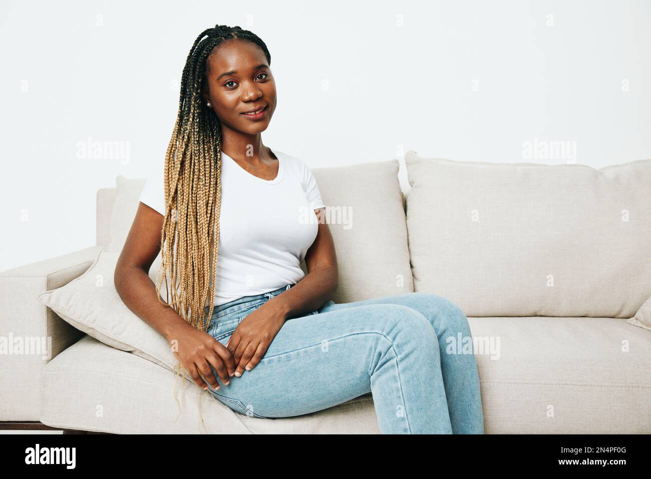 Happy african american woman sitting at home on sofa, rest and vacation ...