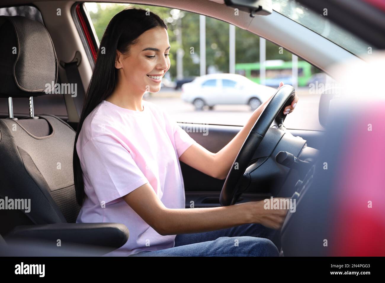 Young woman starting engine of car. Driving school Stock Photo Alamy