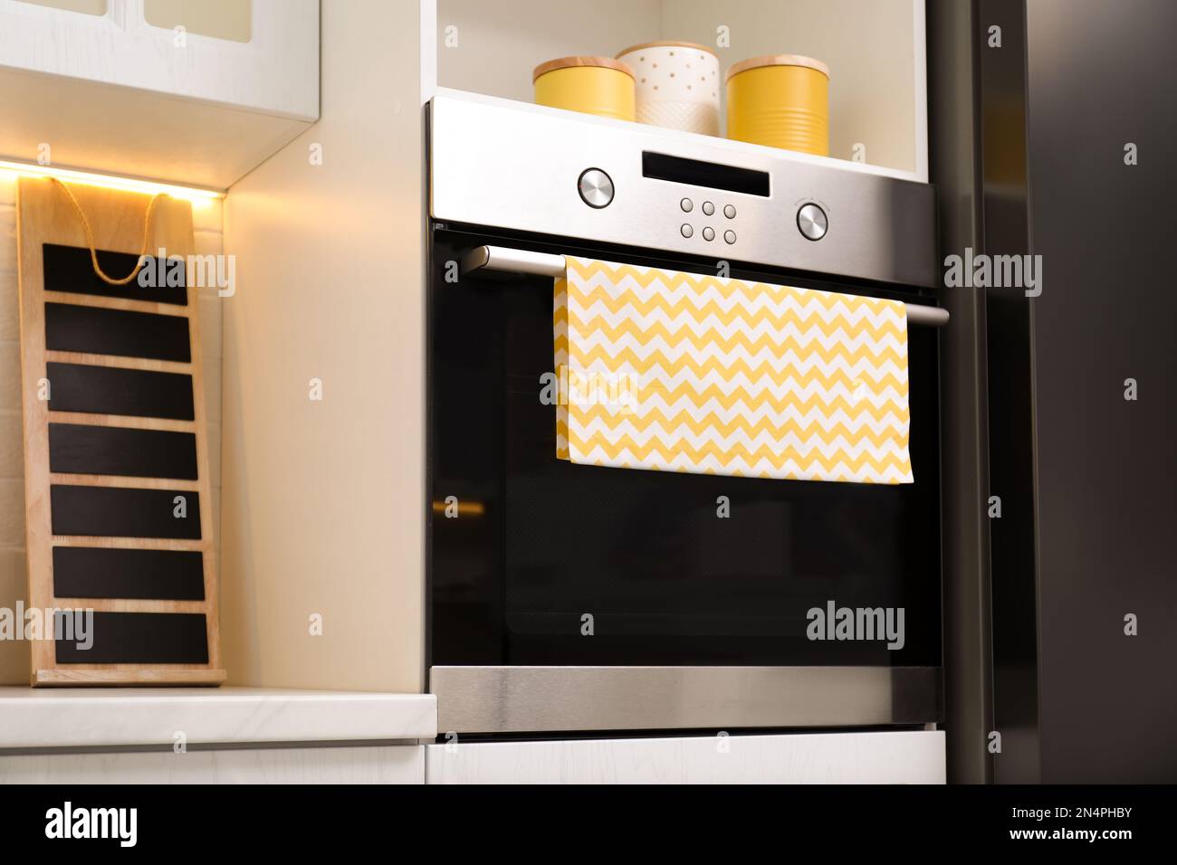 Clean towel on stove door in kitchen Stock Photo Alamy