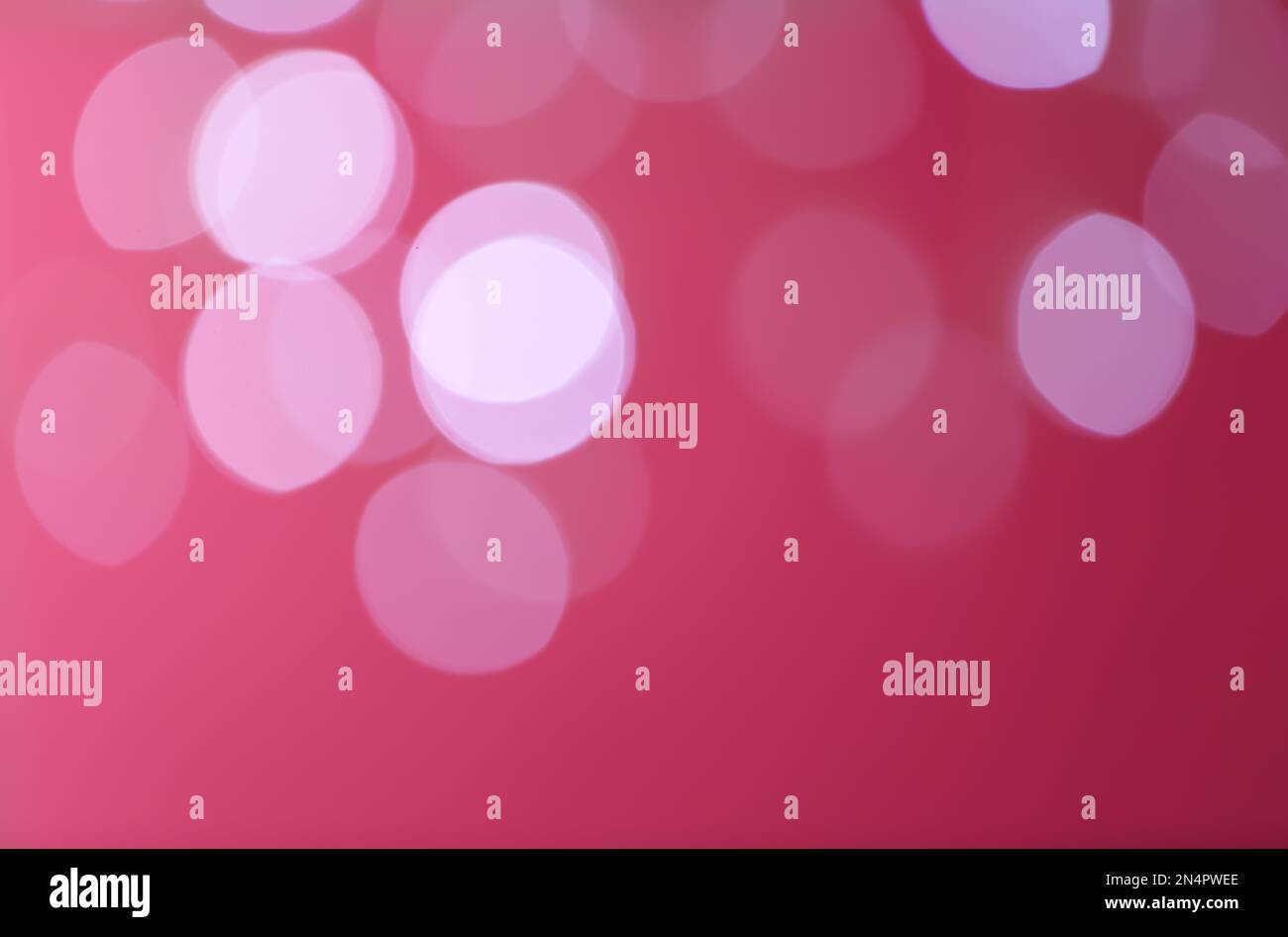 Blurred view of festive lights on red background. Bokeh effect Stock ...