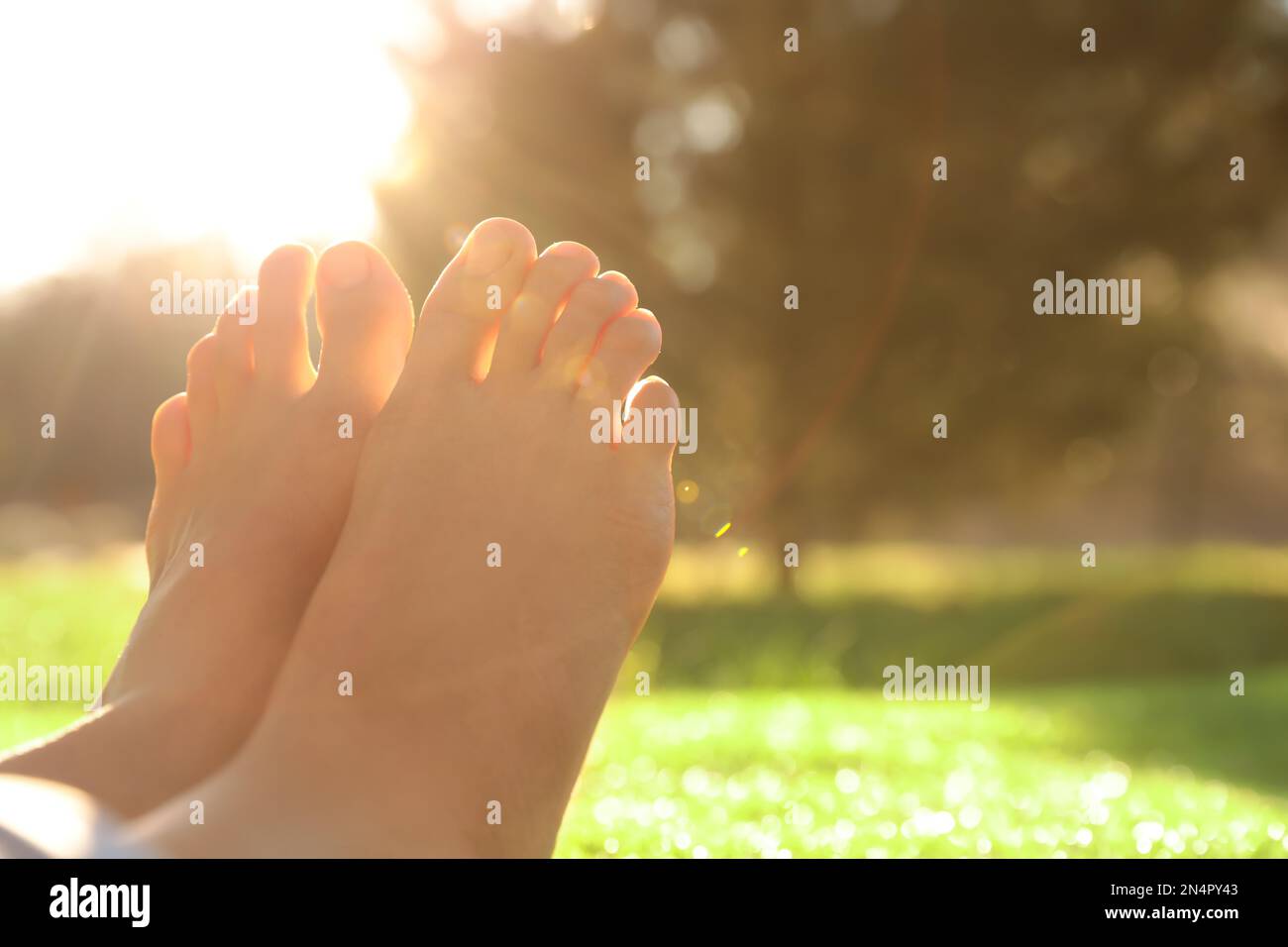 Young woman sitting barefoot hi-res stock photography and images - Alamy