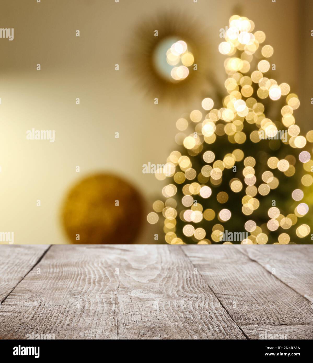 Empty wooden surface and blurred view of Christmas tree in room, space ...