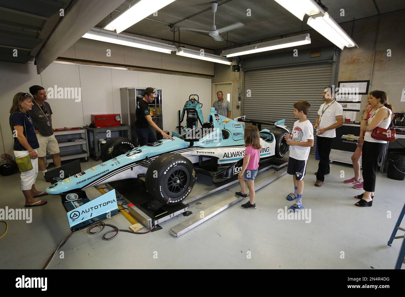 Driver #33 James Davison (center) talks to fans in the garage before ...
