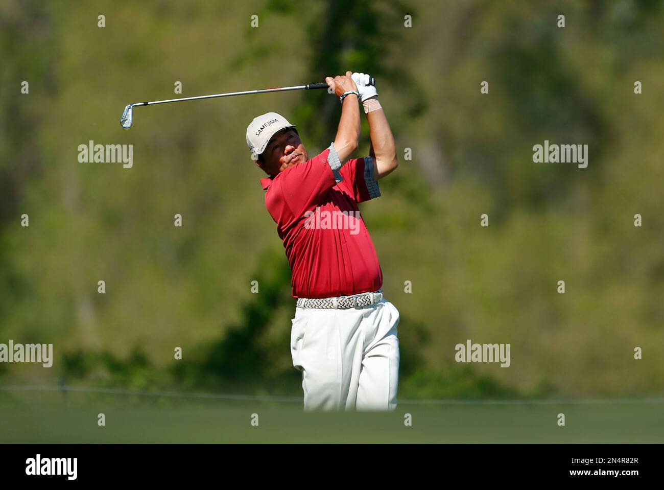 Kiyoshi Murota hits a fairway shot on the 16th hole during the final