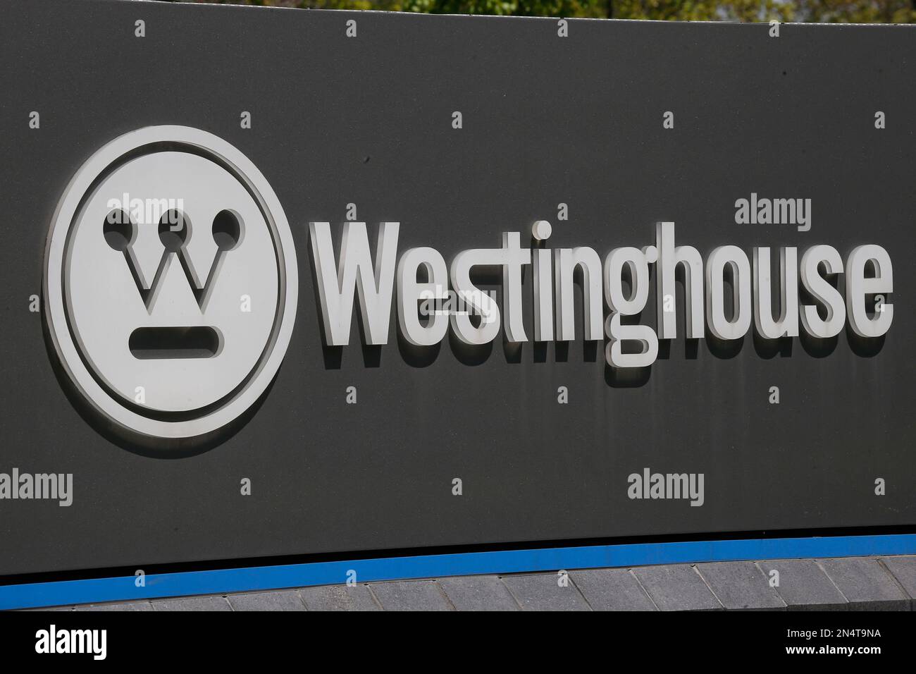 The corporate logo is on the sign marking the driveway to the