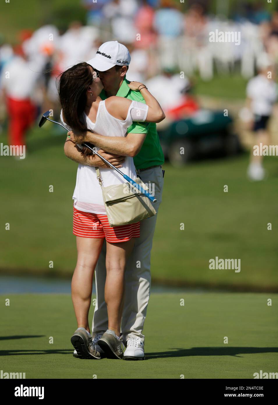 Brendon Todd is kissed by his wife Rachel on the 18th green after Todd